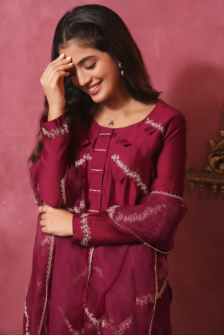  Crafted from pure sheesha silk, this milange outfit features pleated stitching, minimal embroidery, and exquisite pearl and bead work on the back.