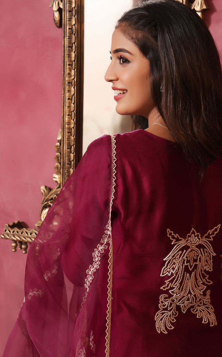  Crafted from pure sheesha silk, this milange outfit features pleated stitching, minimal embroidery, and exquisite pearl and bead work on the back.