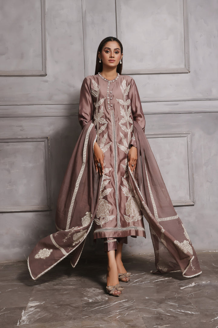  Embrace classic style with Esmee by Mona Imran, featuring unique applique embroidery on pure silk for an elaborate Eid look.