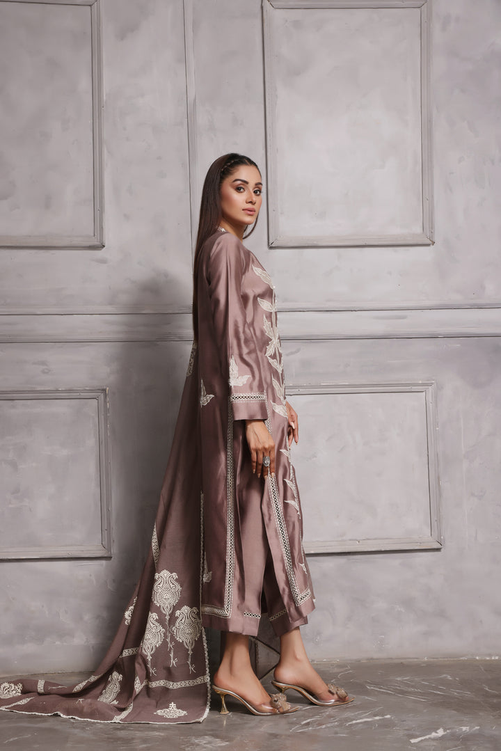  Embrace classic style with Esmee by Mona Imran, featuring unique applique embroidery on pure silk for an elaborate Eid look.