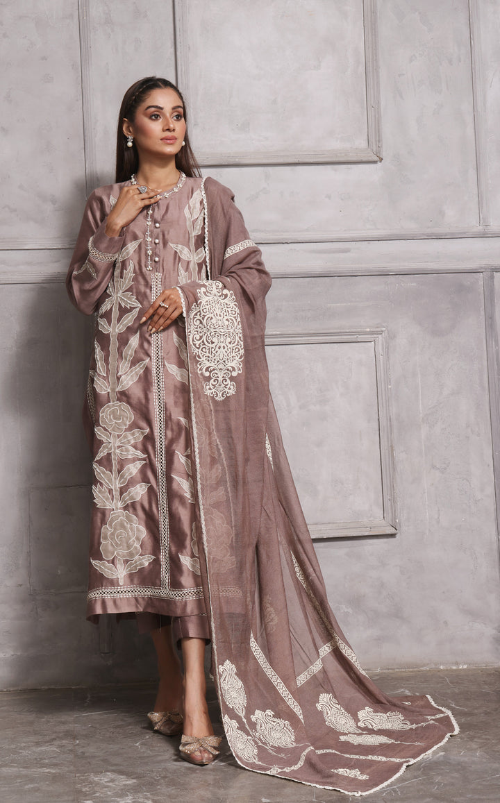  Embrace classic style with Esmee by Mona Imran, featuring unique applique embroidery on pure silk for an elaborate Eid look.