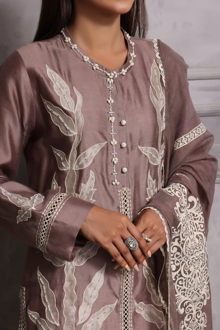  Embrace classic style with Esmee by Mona Imran, featuring unique applique embroidery on pure silk for an elaborate Eid look.