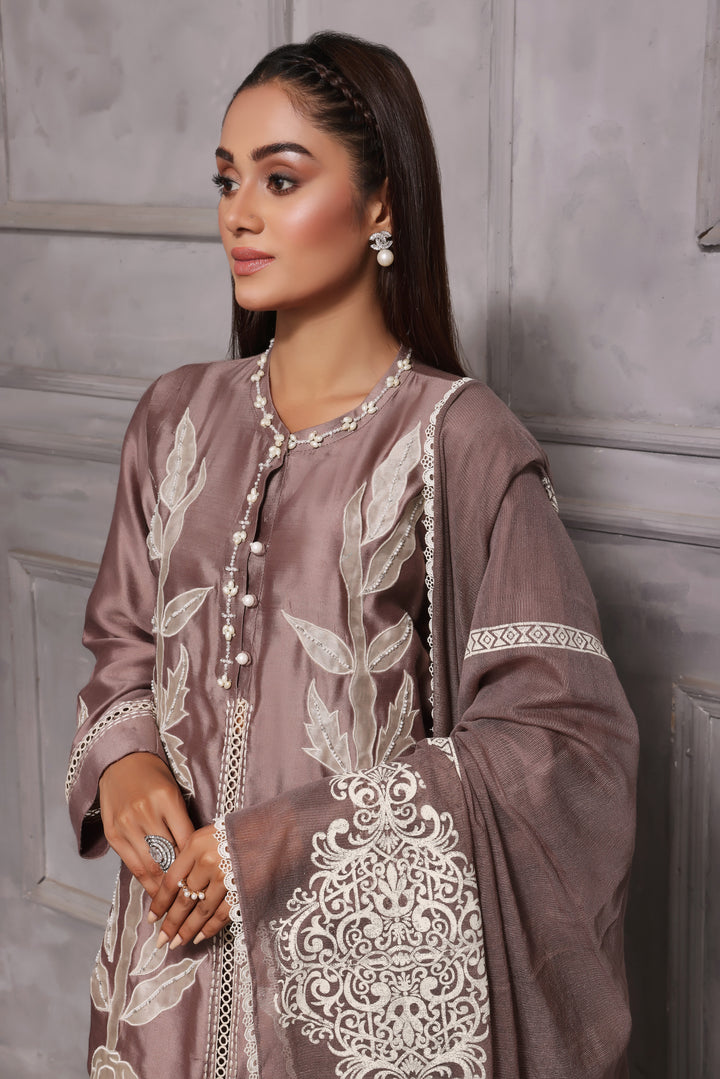  Embrace classic style with Esmee by Mona Imran, featuring unique applique embroidery on pure silk for an elaborate Eid look.