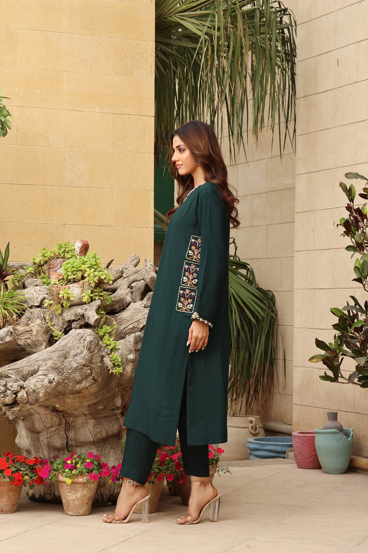  Step into the enchanting depths of Forest by Mona Imran, crafted from emerald green cotton net with exquisite handmade resham and zardozi French knot work.