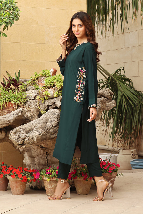  Step into the enchanting depths of Forest by Mona Imran, crafted from emerald green cotton net with exquisite handmade resham and zardozi French knot work.