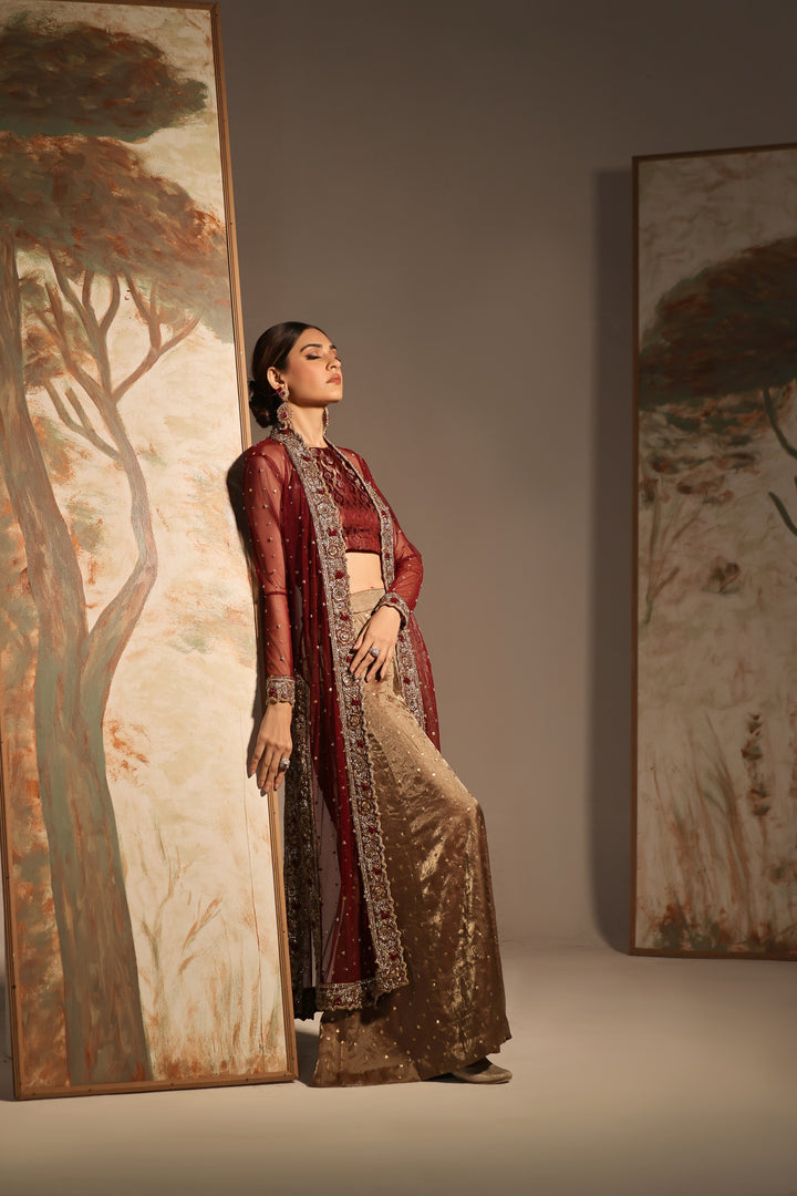  Step into timeless elegance with Gulabposh by Mona Imran, featuring a deep maroon kora net jacket adorned with exquisite antique gold appliquéd borders.