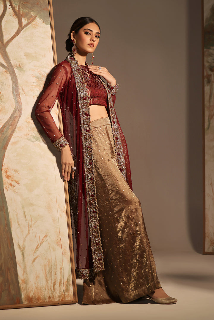  Step into timeless elegance with Gulabposh by Mona Imran, featuring a deep maroon kora net jacket adorned with exquisite antique gold appliquéd borders.