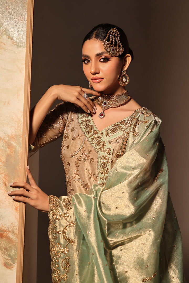 Discover ELYSSA by MONA IMRAN—lambha gold tissue with intricate zardozi, kora dabka, naqshi work. Experience timeless elegance and sophistication.