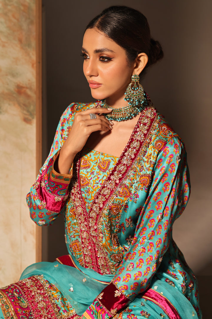   Introducing Liana by Mona Imran, crafted from pure shamoz with exquisite digital prints and handmade zardozi borders, epitomizing grace and style.